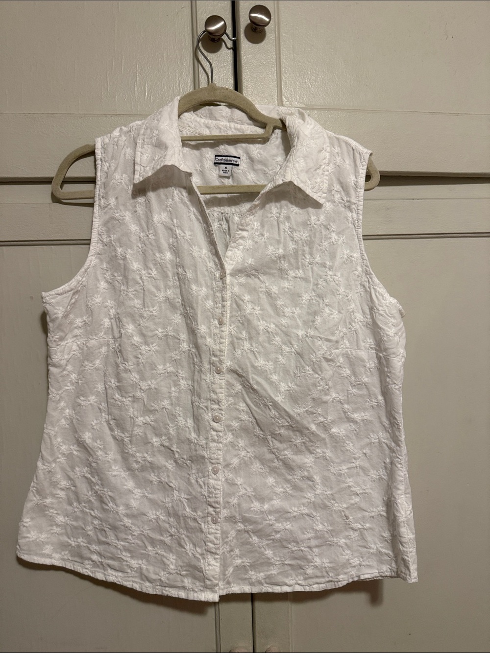 White coastal sleeveless button front top